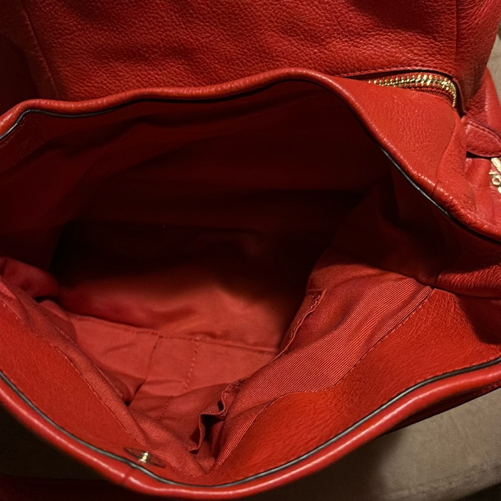 This is a coral coach bag with multiple compartments for great organization!